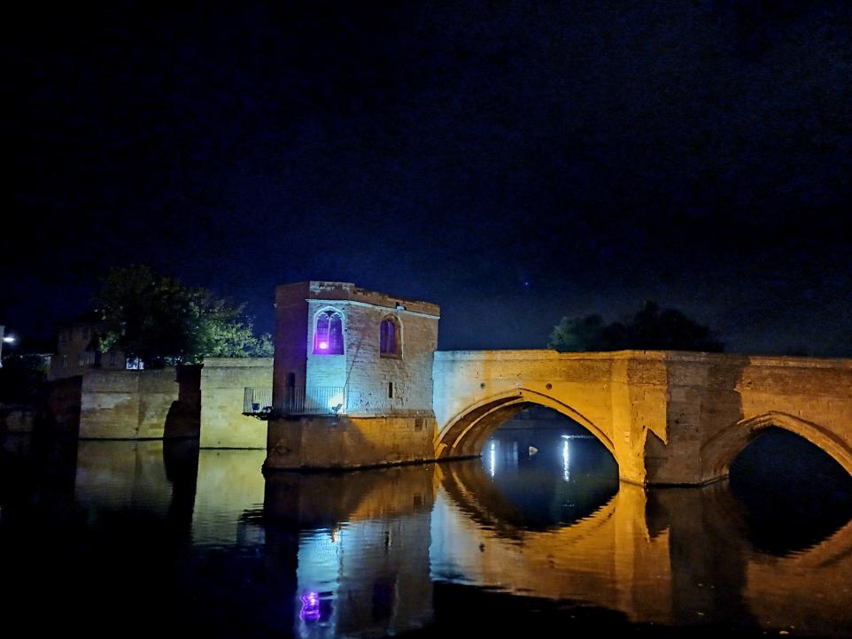 Historic St Ives Bridge over the River Great Ouse illuminated at night in Cambridgeshire.